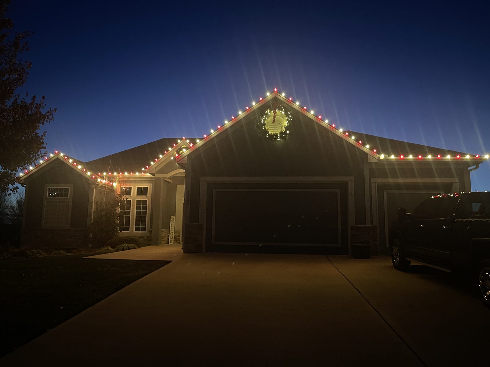 Residential Christmas light installation — evening view