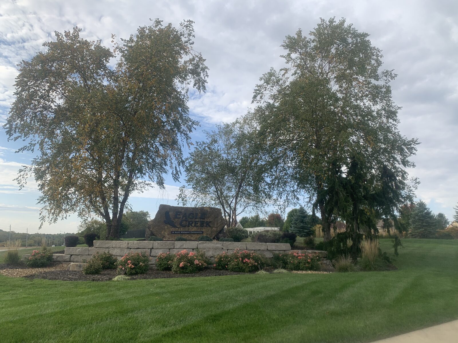 Holiday lighting installation on residential property at dusk